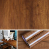 Roll of self-adhesive wood grain waterproof wallpaper next to white sheep.