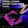 A hand wearing a black glove is using a bright pink coral down short hair fiber towel on a dark car surface.