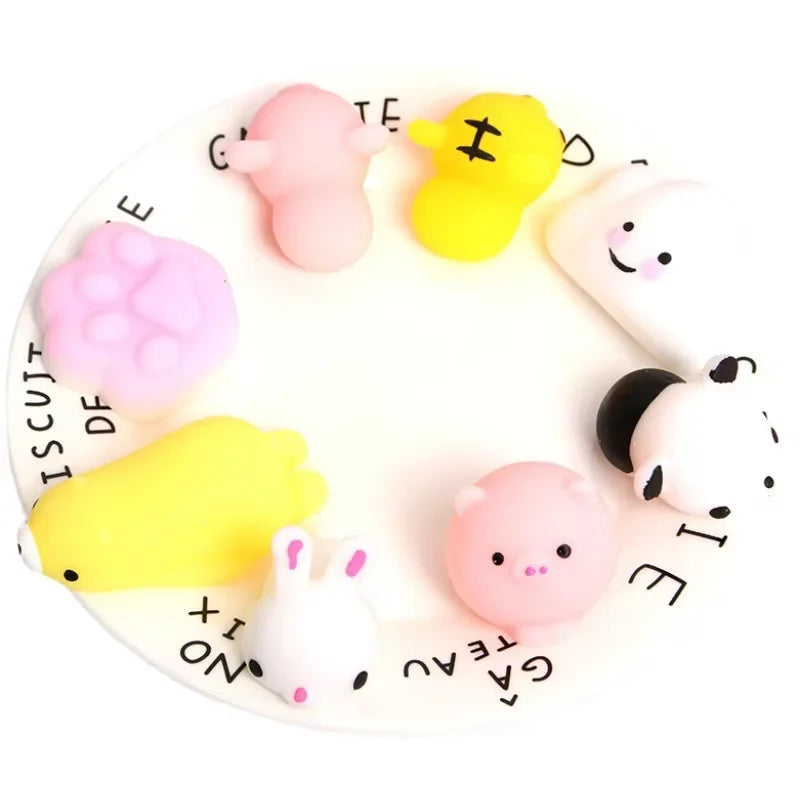 A white plate with eighteen pink and yellow animal squeeze stress relief toys arranged around the edge.