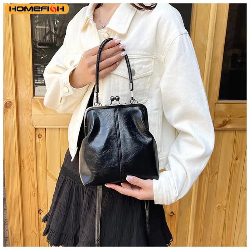 A woman is holding a black PU leather crossbody handbag against a wooden door background.