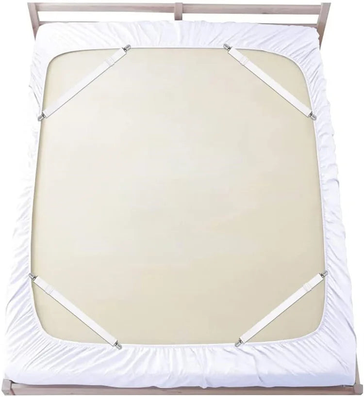 White elastic bed sheet with four corner straps on a wooden bed frame.