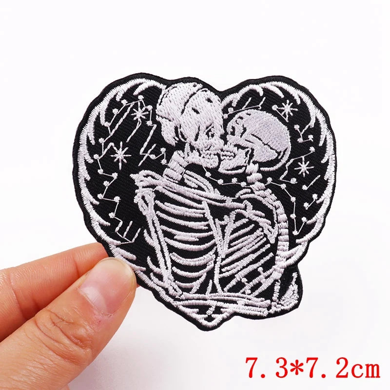 Black embroidered patch featuring a skull design with stars and a heart shape.