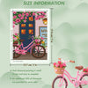 A square diamond art kit featuring a colorful house and a pink bicycle, with size information displayed.