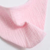 Pink organic cotton muslin baby bibs with an absorbent bandana shown in a close-up fold.