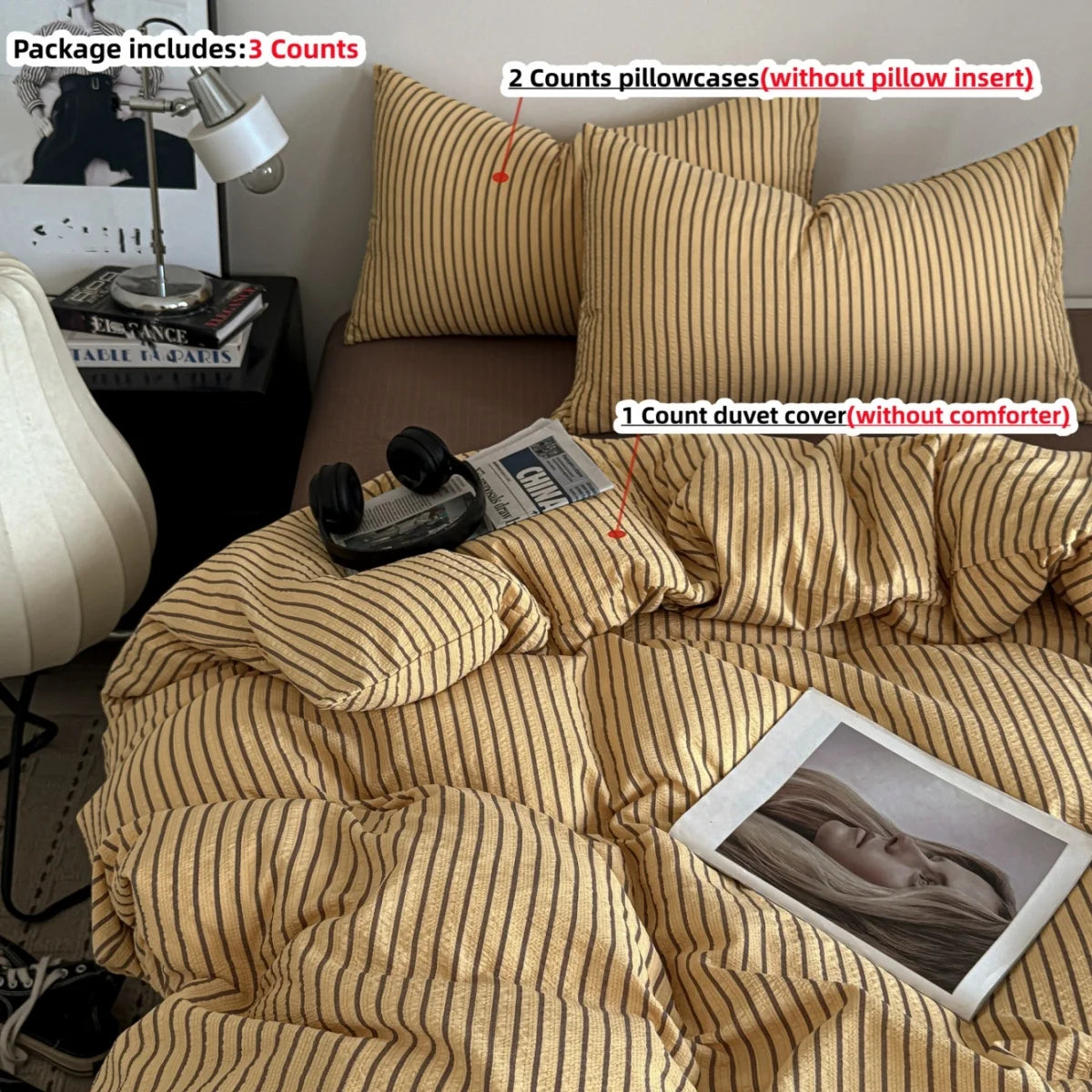 A beige and gold striped duvet cover set with two pillowcases and a duvet cover shown on a bed.