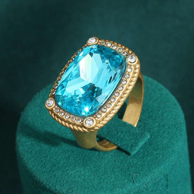 Vintage sea blue crystal cocktail ring set on a dark green velvet surface
