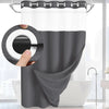 A gray dotted waffle weave shower curtain hanging on a rod in a bathroom setting.