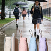 A collection of five ultra-compact 5-fold umbrellas in various pastel colors displayed on a surface.