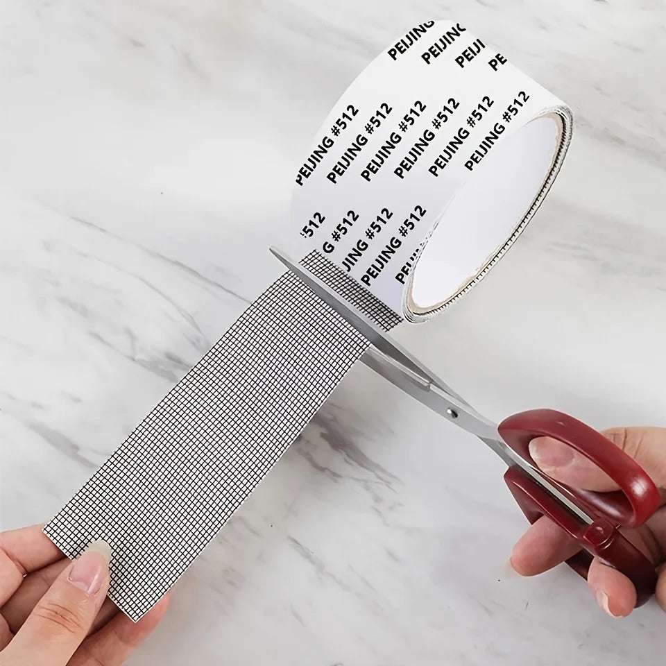 A hand holds a roll of self-adhesive window screen repair tape with various numbered patches on a white marble surface.