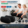 A man and a woman are shown using black reusable shoe washing bags to clean sneakers in a washing machine.