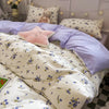 Pink floral bedding set featuring a duvet cover and pillows with a white background.