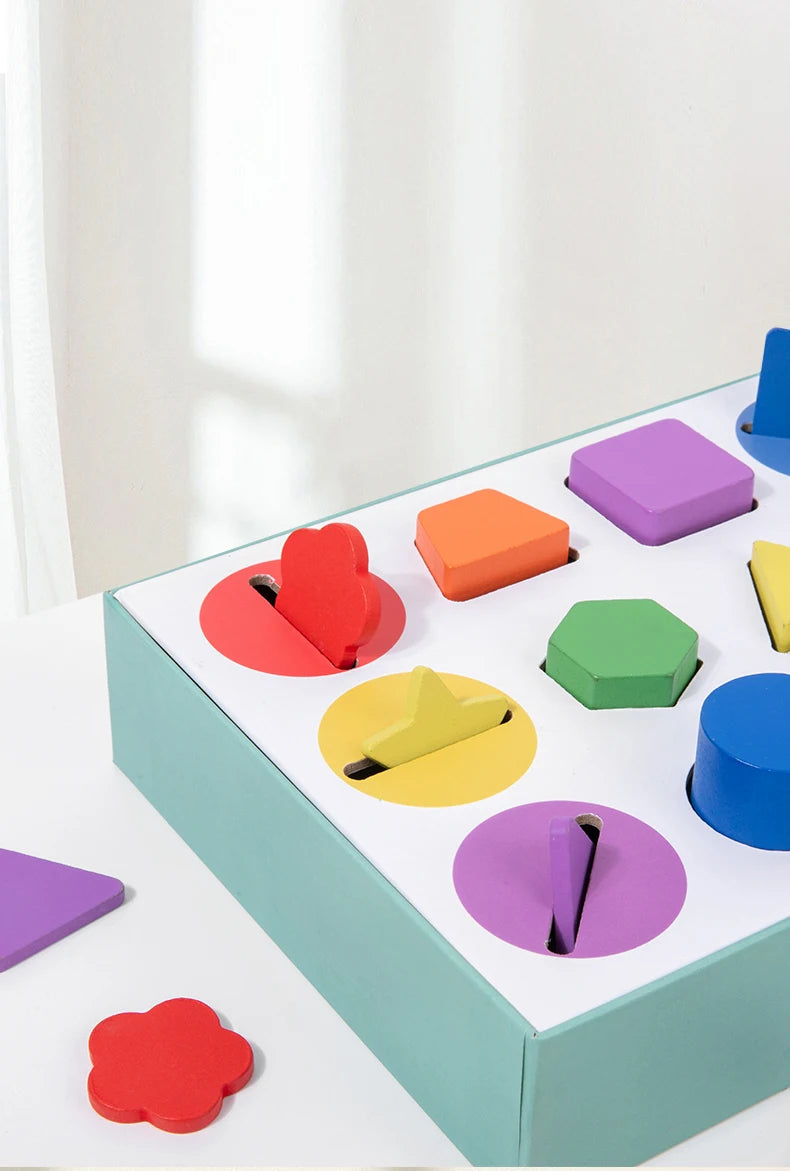 A wooden geometric shape and color sorting box filled with colorful blocks for toddlers.