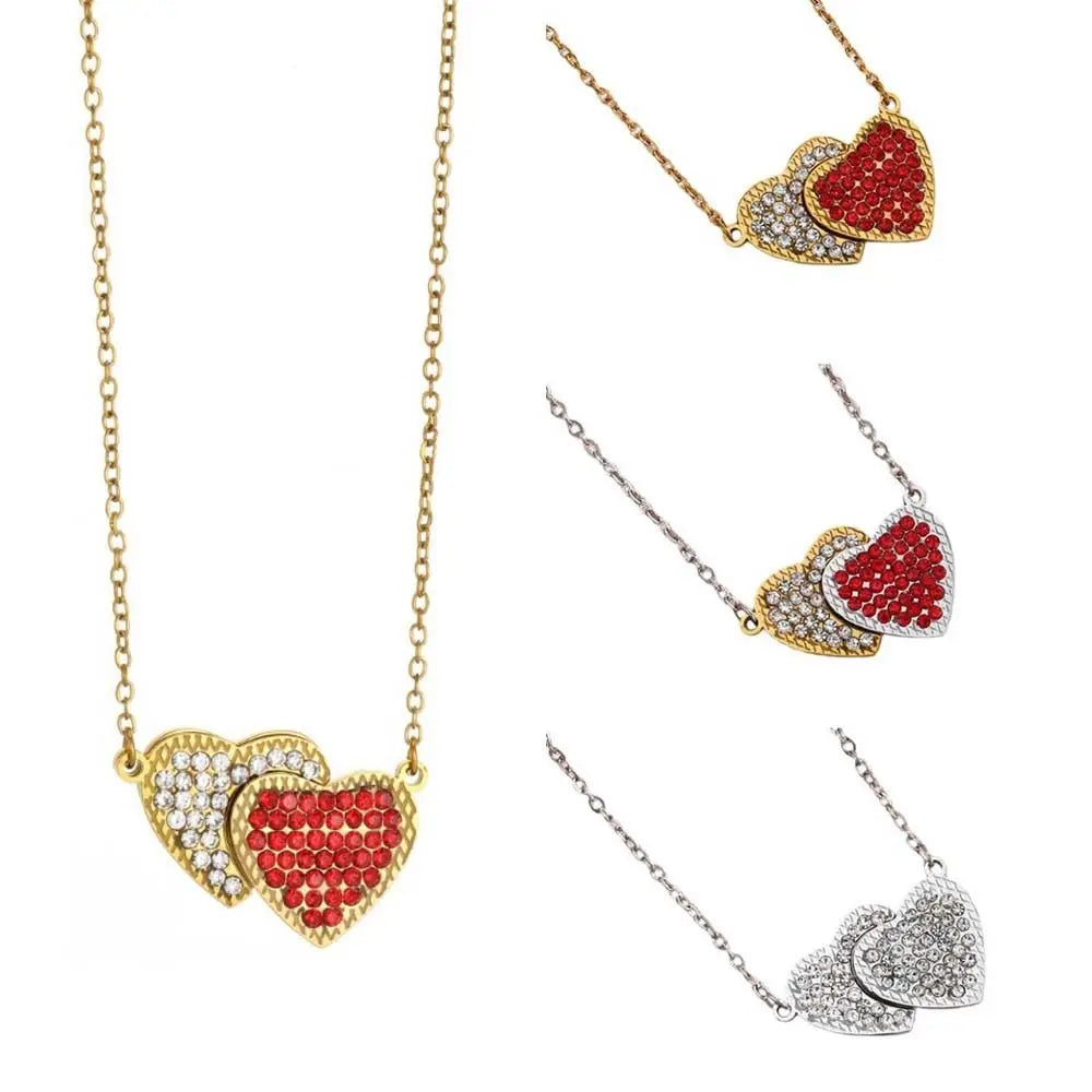 A collection of magnetic heart pendant necklaces featuring red and gold stones.