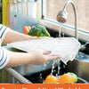 A hand is using a collapsible mesh food cover to wash fruits and vegetables under a kitchen faucet.