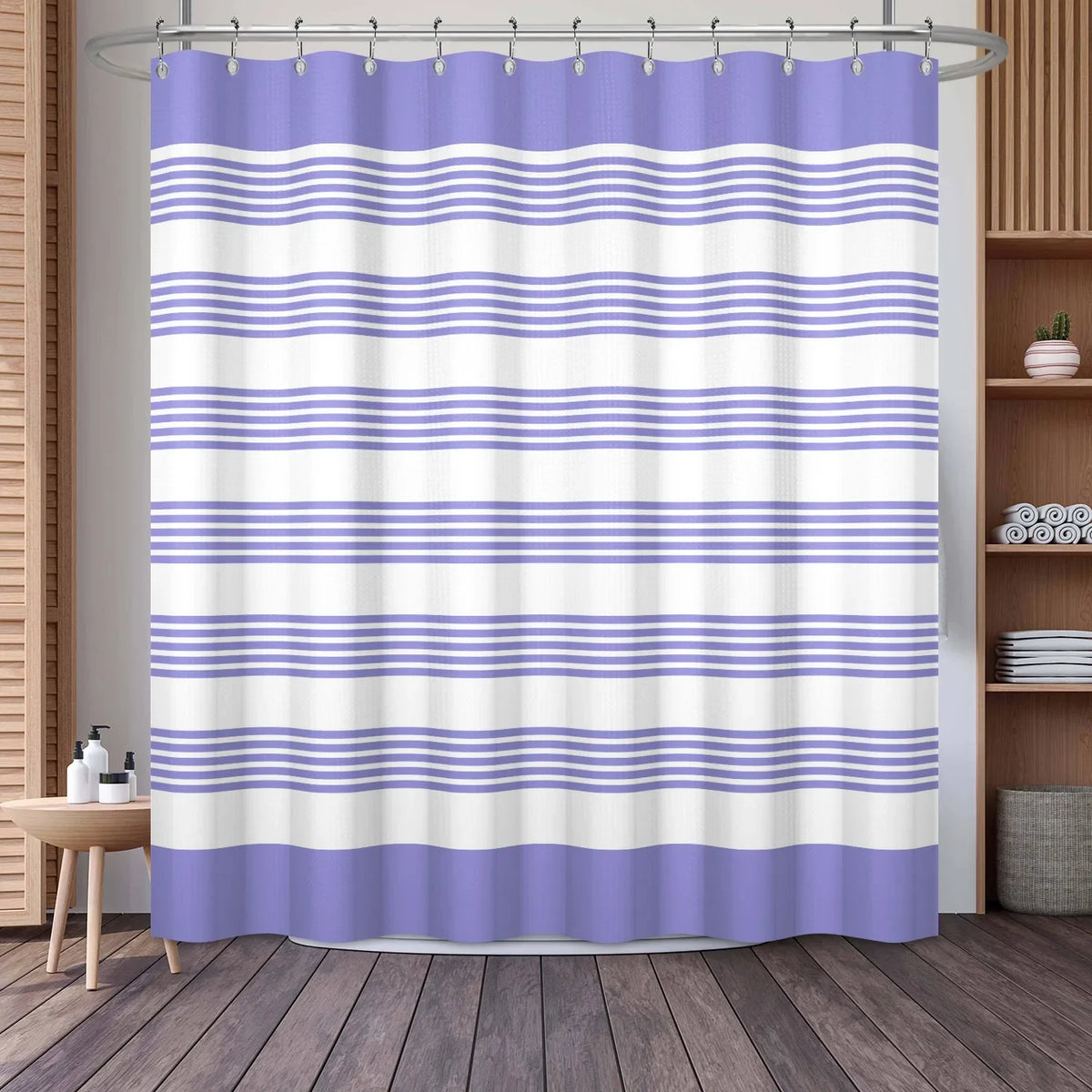 A purple and white striped waffle weave shower curtain hanging in a bathroom setting.