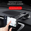 A hand is adjusting a black 360° rotating car phone mount with suction cup and air vent clips on a dashboard.