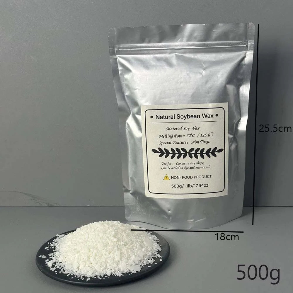 A bag of Natural Soybean Wax flakes next to a pile of white wax on a dark plate.