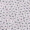 A close-up view of numerous white acrylic alphabet letter beads scattered on a white surface.