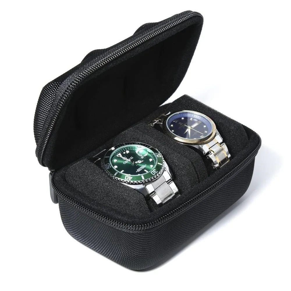 A black portable leather watch travel case with a soft lining, open to display a silver-toned wristwatch.