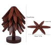 A wooden tree design coaster featuring folding placemats, made of dark brown wood.