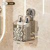 A silver wall-mounted suction cup storage basket with a water ripple design and an attached glass bottle.
