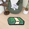 A green tufted mat featuring a cartoon dollar bill design on a light wood floor.