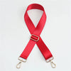 A bright red nylon bag strap with a gold buckle shown diagonally.