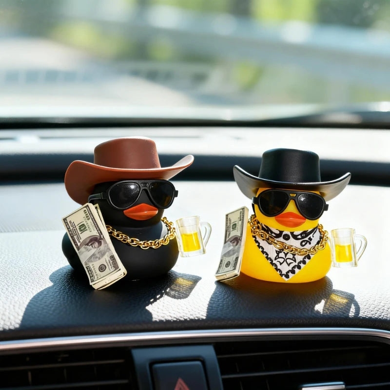 A rubber duck car ornament featuring a cowboy hat and sunglasses sits on a dashboard.