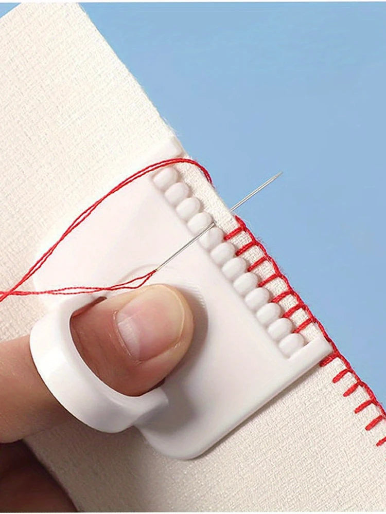 A hand is using a white sewing guide template with red thread and a needle to mark stitches on fabric.