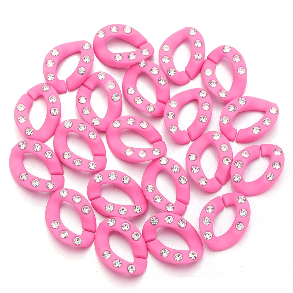 A set of twenty pink acrylic jewelry connector clasps with crystal accents arranged on a white background.