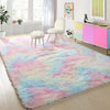 Flauschiger tiegedruckter Teppich in Pastellrosa, Blau und Grün auf hellem Holzfußboden.