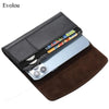 A black magnetic leather phone pouch with a belt clip holster is shown resting on a brown leather pad.