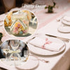 Party decor featuring a glass jar filled with colorful pom-poms and a plate with a pink ribbon label