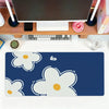 A dark blue mouse pad featuring white and yellow floral designs for office or gaming use.
