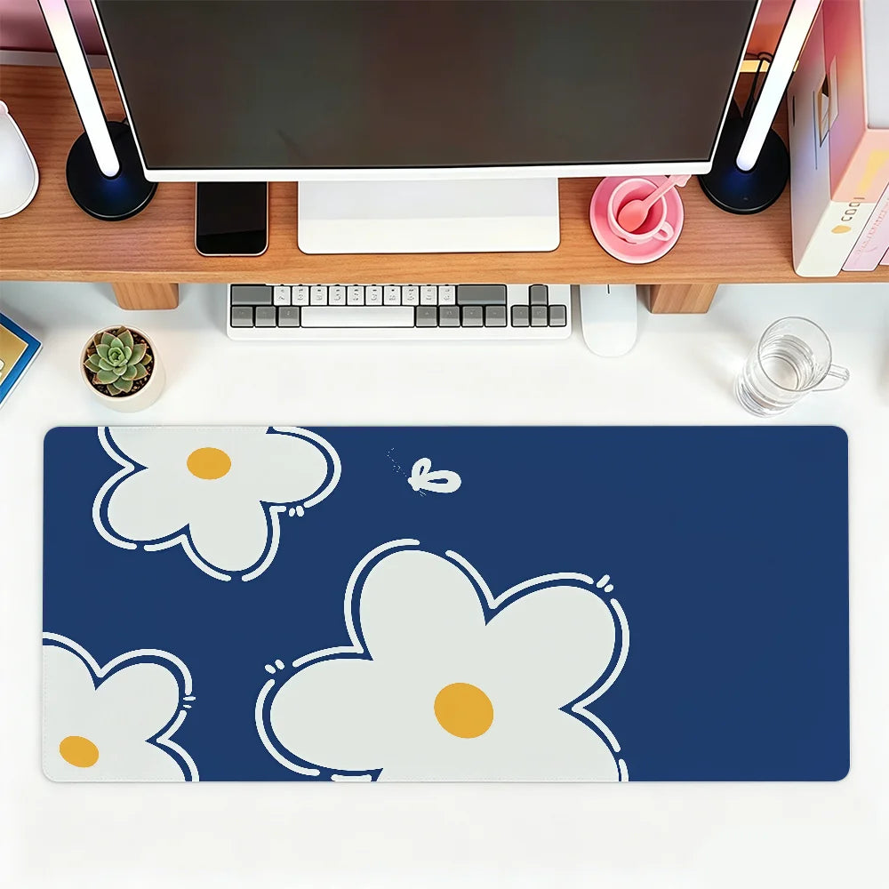 A dark blue mouse pad featuring white and yellow floral designs for office or gaming use.