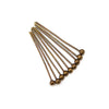 A set of gold-plated brass ball head pins for jewelry making arranged diagonally.