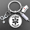 Silver necklace keychain featuring a glass dome charm with the text I LOVE NURSING and a medical cross symbol