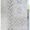 Close-up of a wall covered in gray and white brick pattern, showing a section of the decorative frosted window privacy film.
