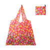 A bright pink floral reusable shopping tote bag with a matching fabric carry pouch.