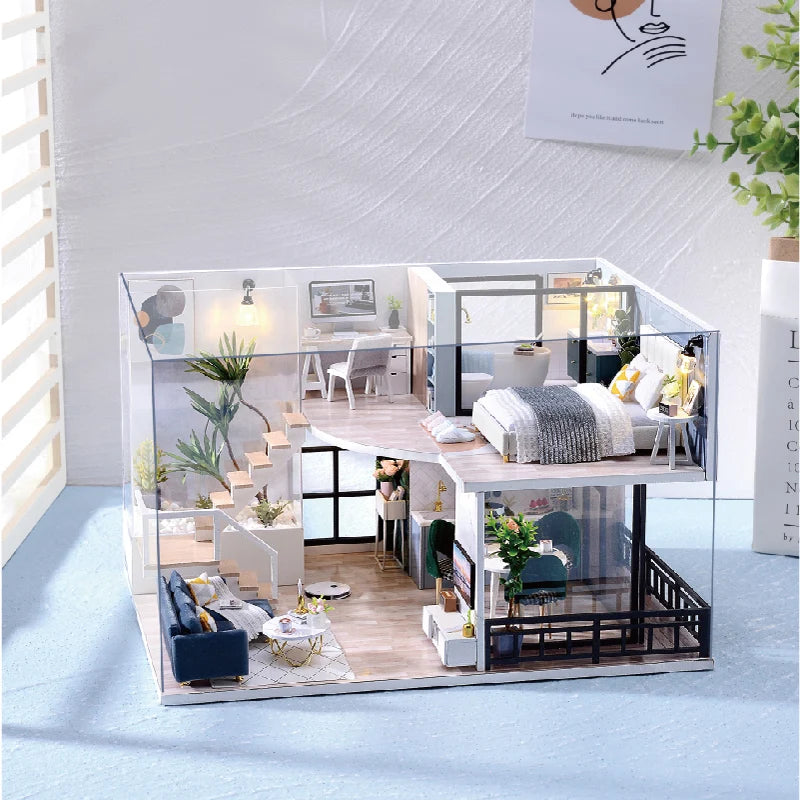 A clear acrylic miniature dollhouse building kit featuring wooden furniture and interior details.
