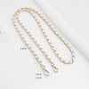 Gold-toned metal chain shoulder strap buckle for a crossbody bag