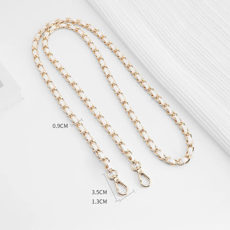 Gold-toned metal chain shoulder strap buckle for a crossbody bag