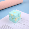A light blue infinity magic cube fidget toy resting on a white sheet of paper.