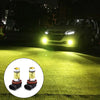 A pair of H11/H8 LED fog light bulbs with yellow color and silver housing shown on a green lawn.
