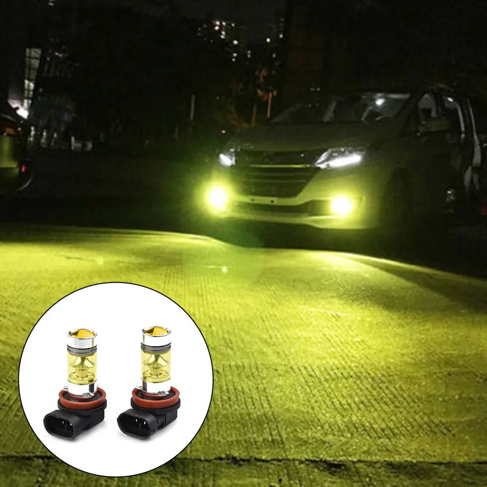 A pair of H11/H8 LED fog light bulbs with yellow color and silver housing shown on a green lawn.