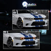 A white Dodge Charger with blue racing stripes and LED front grille lights.
