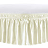 A cream-colored adjustable wrap-around bed skirt with elegant ruffles.