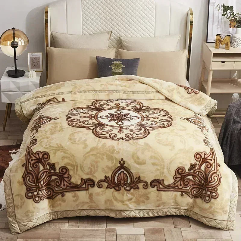 A beige weighted plush raschel blanket with brown decorative embroidery is displayed on a bed.
