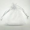 A clear white organza drawstring bag tied at the top, suitable for gifts or party favors.