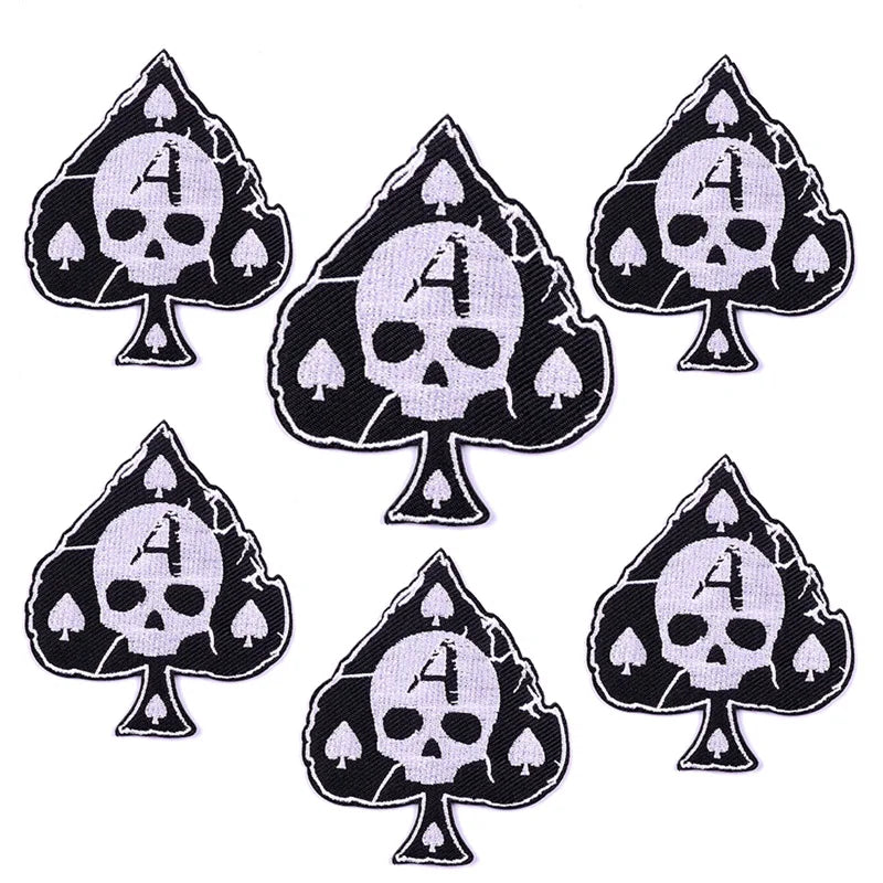 A set of ten black and white rock skull embroidered iron-on patches shaped like trees.
